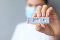 Woman holding Rapid Antigen Test kit with Negative result during swab COVID-19 testing. Coronavirus Self nasal or Home test, Royalty Free Stock Photo