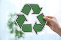 Woman holding recycling symbol on blurred background Royalty Free Stock Photo