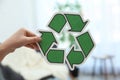 Woman holding recycling symbol on blurred background Royalty Free Stock Photo