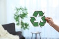 Woman holding recycling symbol on blurred background, closeup Royalty Free Stock Photo