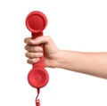 Woman holding red corded telephone handset on white background, closeup. Hotline concept Royalty Free Stock Photo