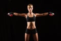 Woman holding red dumbbells