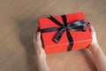 A woman holding a red gift box between her hands. Happy valentineÃ¢â¬â¢s day, red color, heart icon, isolated background Royalty Free Stock Photo