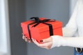 A woman holding a red gift box between her hands. Happy valentineÃ¢â¬â¢s day, red color, heart icon, isolated background. Royalty Free Stock Photo