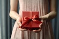 woman holding a red gift box with red ribbon Royalty Free Stock Photo