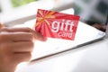 Woman Holding Red Gift Card