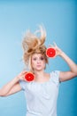 Woman holding red grapefruit having crazy windblown hair Royalty Free Stock Photo