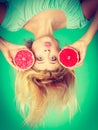 Woman holding red grapefruit having crazy windblown hair Royalty Free Stock Photo