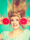 Woman holding red grapefruit having crazy windblown hair Royalty Free Stock Photo