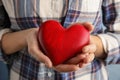 Woman holding red heart in hands