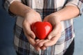 Woman holding red heart in hands, closeup