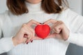 A woman holding a red heart between her hands. Happy valentineÃ¢â¬â¢s day, red color, heart icon,  background Royalty Free Stock Photo