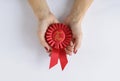 Woman holding a red 2nd place winners rosette