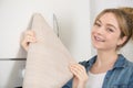 woman holding roll veneer to revamp kitchen cupboards