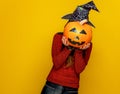 Woman holding sad jack-o-lantern pumpkin in front of face Royalty Free Stock Photo