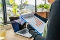 Woman holding sales diagram at rustic workplace by the window