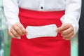 Woman holding sanitary napkins with red skirt - woman on her per Royalty Free Stock Photo