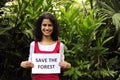 Woman holding a save the forest sign Royalty Free Stock Photo