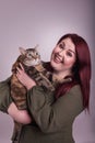 Woman holding scared unsure calico cat smiling