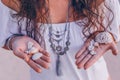 Woman holding sea shells in hands close up