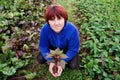 Woman holding a seedling in her hands