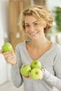 woman holding several apples