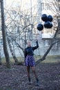 woman holding several balloons