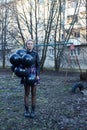 woman holding several balloons