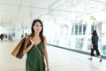 Woman holding shopping bag ans walking along the street Royalty Free Stock Photo