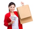 Woman holding shopping bag and cash Royalty Free Stock Photo