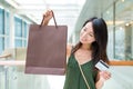 Woman holding shopping bag and credit card Royalty Free Stock Photo