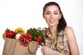 Woman holding a shopping bag full of fresh food Royalty Free Stock Photo