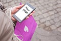Woman holding shopping bag and mobile phone. Royalty Free Stock Photo