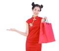 woman holding shopping bag and open hand palm in concept of happy chinese new year isolated on white background Royalty Free Stock Photo