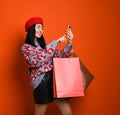 Woman holding shopping bag and using smartphone for shopping online, shopping concept. Royalty Free Stock Photo