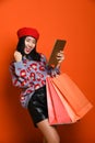 Woman holding shopping bag and using smartphone for shopping online, shopping concept. Royalty Free Stock Photo