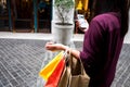 Woman holding shopping bag and using smartphone for shopping online, shopping concept. Royalty Free Stock Photo