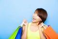 woman holding shopping bags before blue background Royalty Free Stock Photo