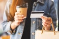 A woman holding shopping bags , credit card and coffee cup Royalty Free Stock Photo