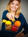 Woman holding shopping basket with fruits inside Royalty Free Stock Photo