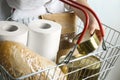 Woman holding shopping basket with products and toilet paper rolls. Panic caused by virus Royalty Free Stock Photo