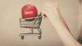 Woman holding shopping cart with apple inside Royalty Free Stock Photo