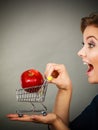 Woman holding shopping cart with apple inside Royalty Free Stock Photo