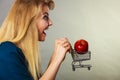 Woman holding shopping cart with apple inside Royalty Free Stock Photo