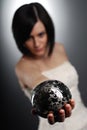 Woman holding a silver magic ball Royalty Free Stock Photo