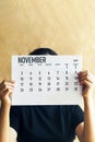 A woman holding simple November at 2019 calendar