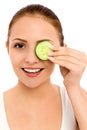 Woman holding slice of cucumber Royalty Free Stock Photo