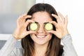 Woman holding slice of cucumber Royalty Free Stock Photo