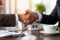 A woman holding a small model house in her hands. Real estate and insurance concept. Generative AI Royalty Free Stock Photo