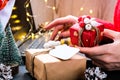 Woman holding small present box in hand and using search by laptop. Christmas Concept. Online shopping. Holiday sale Royalty Free Stock Photo